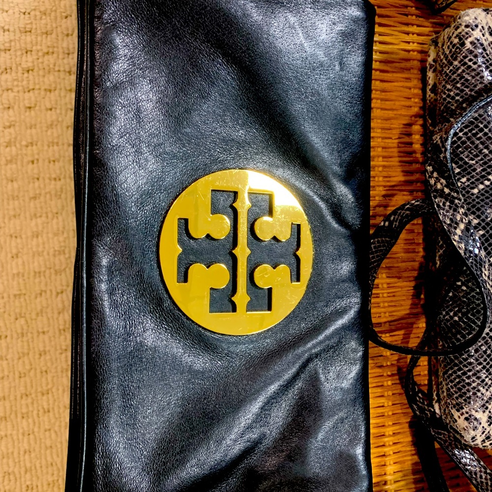 Tory burch leather clutch with gold monogram logo. Zippered clutch.Hardly used